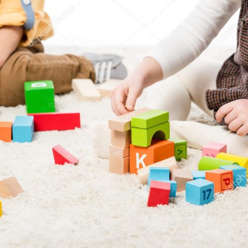 depositphotos_334250112-stock-photo-cropped-view-children-playing-wooden
