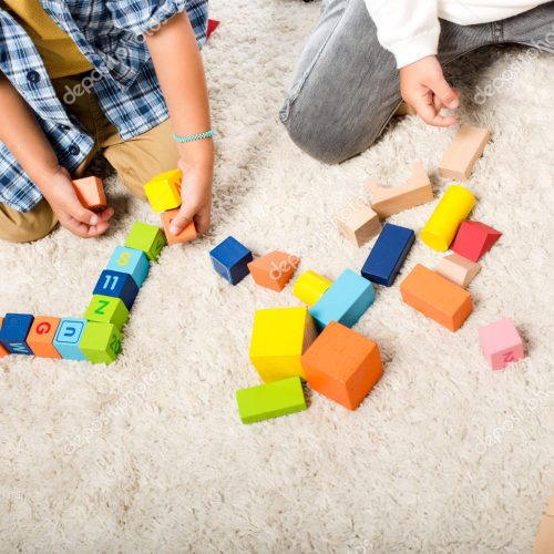 depositphotos_334250240-stock-photo-cropped-view-kids-playing-wooden